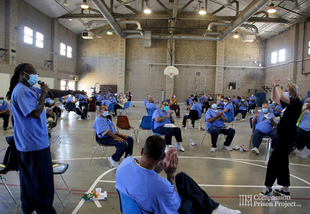 Two people talking in front of group