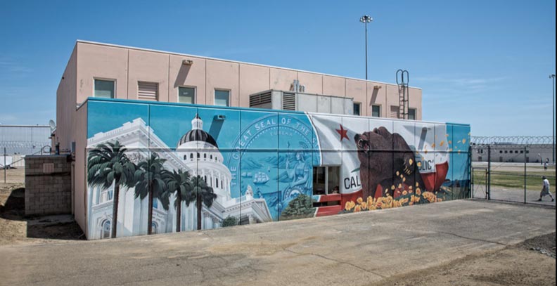 Outside mural of bear and outdoors with government building